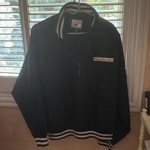 Cutter & Buck navy jacket with navy and white collar, cuffs, and bottom.